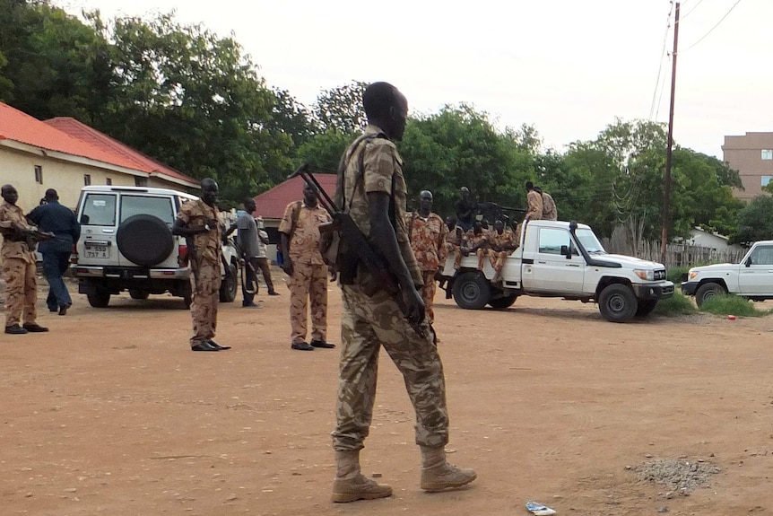 South Sudanese policemen and soldiers standing in a street.