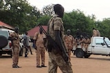 South Sudanese policemen and soldiers standing in a street.
