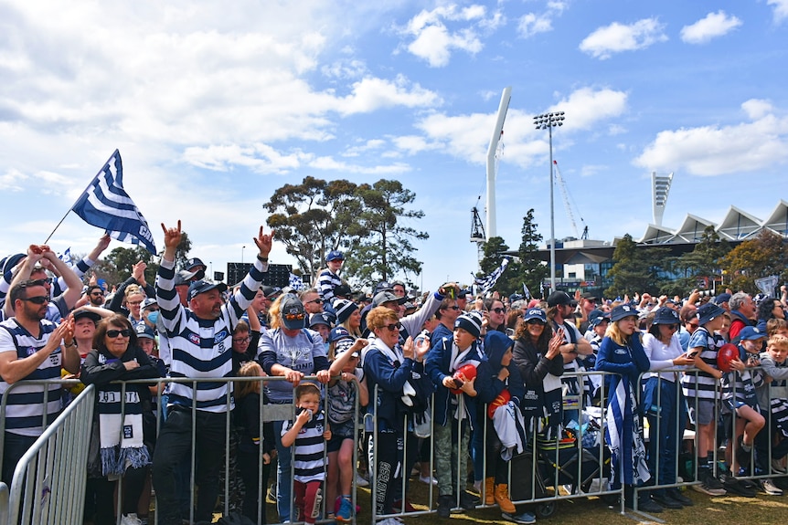 A crowd of Geelong Cats supporters celebrating.