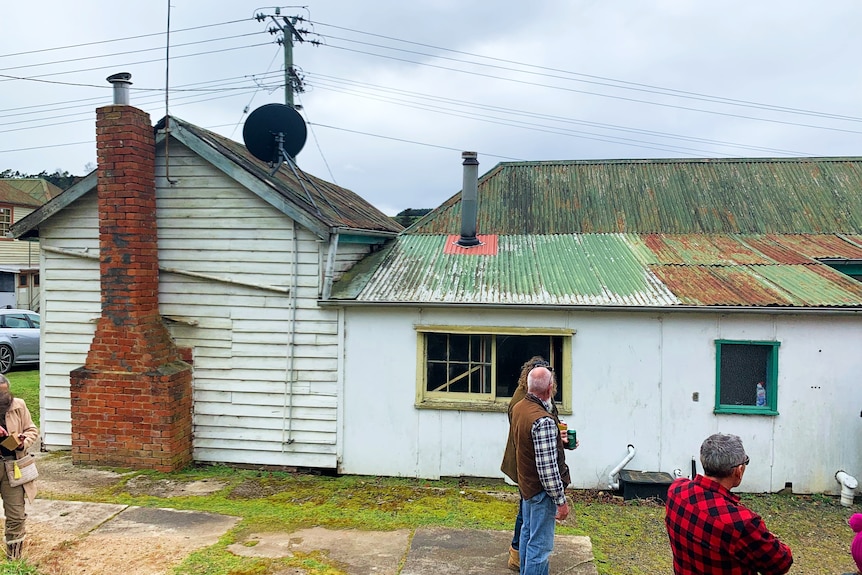 An old house with rusted tin roof.