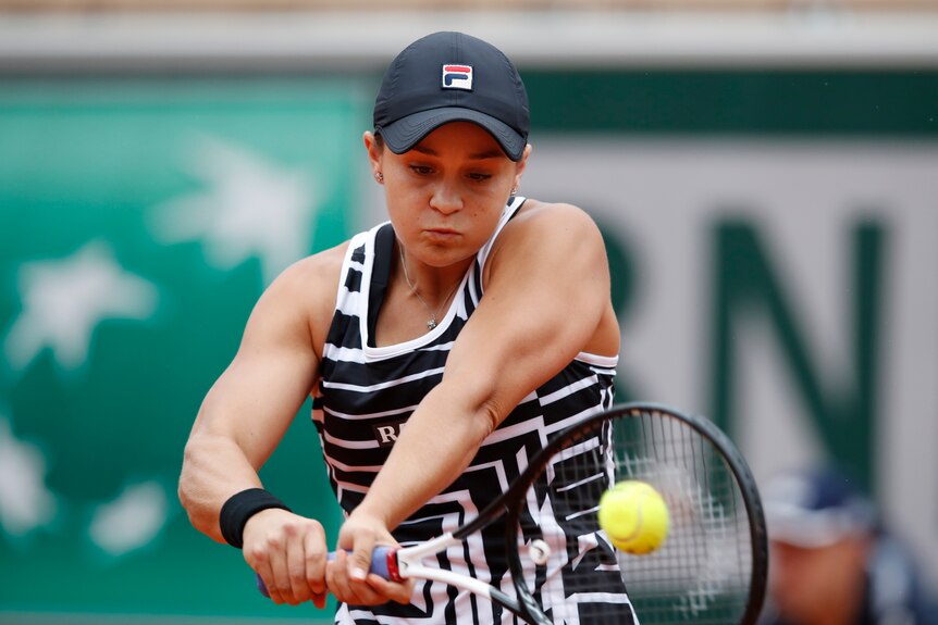 Ash Barty looks at the ball as she hits a two-handed back hand shot
