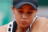 Ash Barty looks at the ball as she hits a two-handed back hand shot