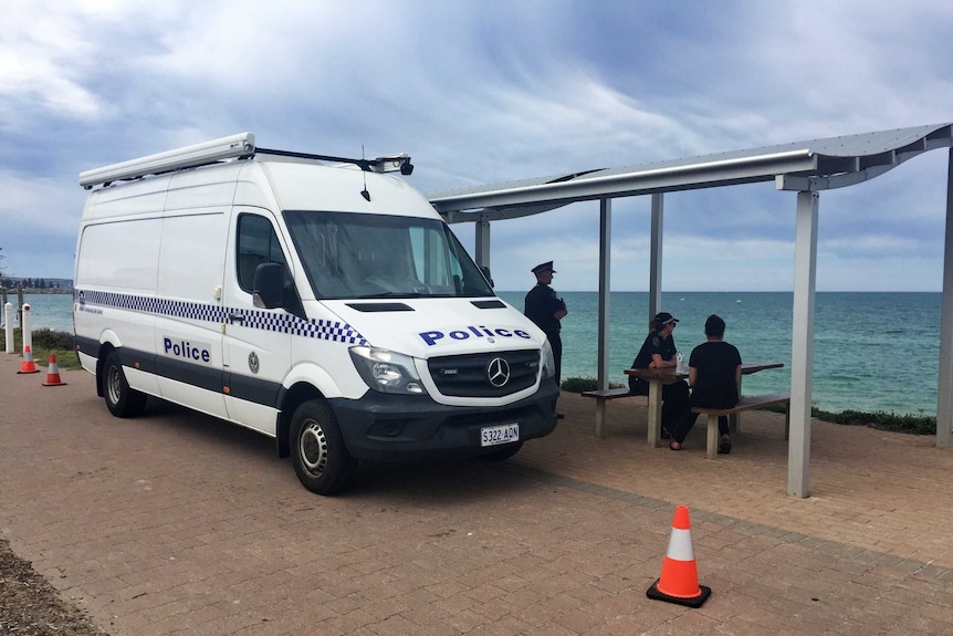 A police van at Glenelg Beach
