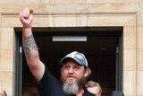 Unionist Ark Tribe celebrates outside Adelaide Magistrates Court