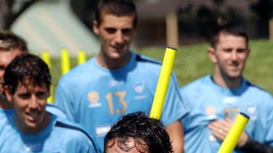 Mark Milligan of Sydney FC darts through sprint markers at training