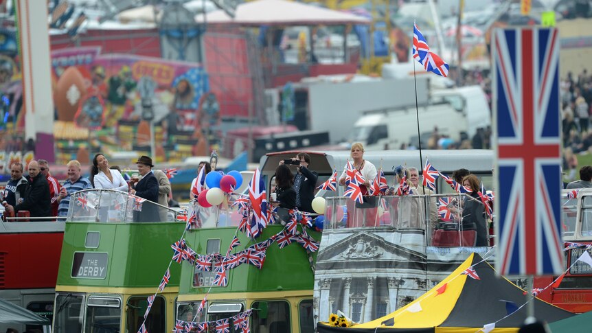 Racegoers watch the action from the top of open-top buses on Derby Day.