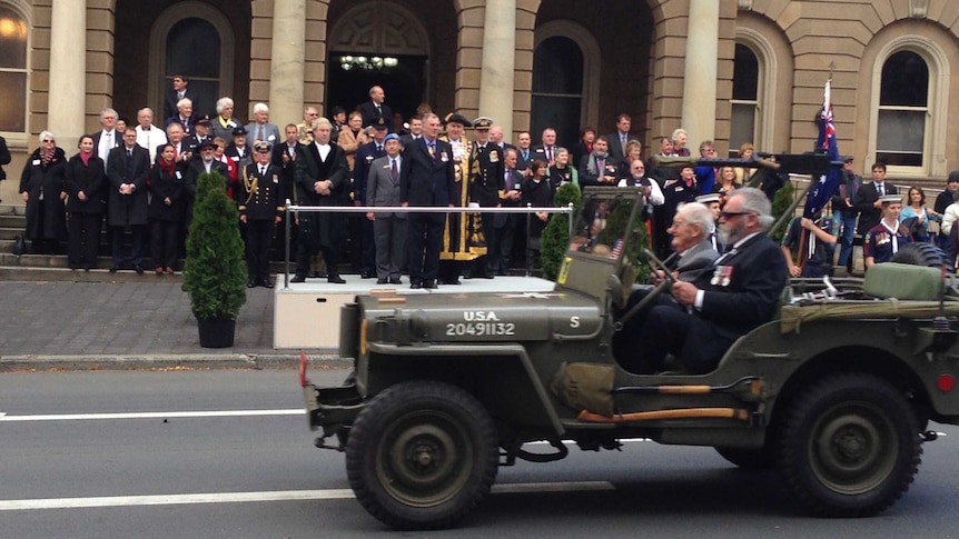 The Governor Peter Underwood watches the Anzac Day parade from the Hobart Town Hall.
