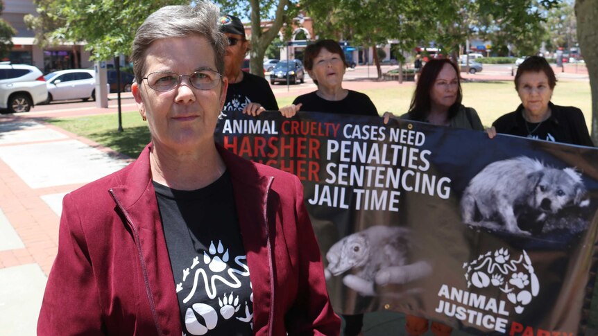 Jehni Thomas-Worth and Animal Justice Party supporters pose for a photo outside Joondalup Magistrates Court.