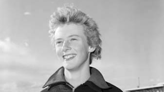 Mid shot of of a young Betty Cuthbert in black and white.
