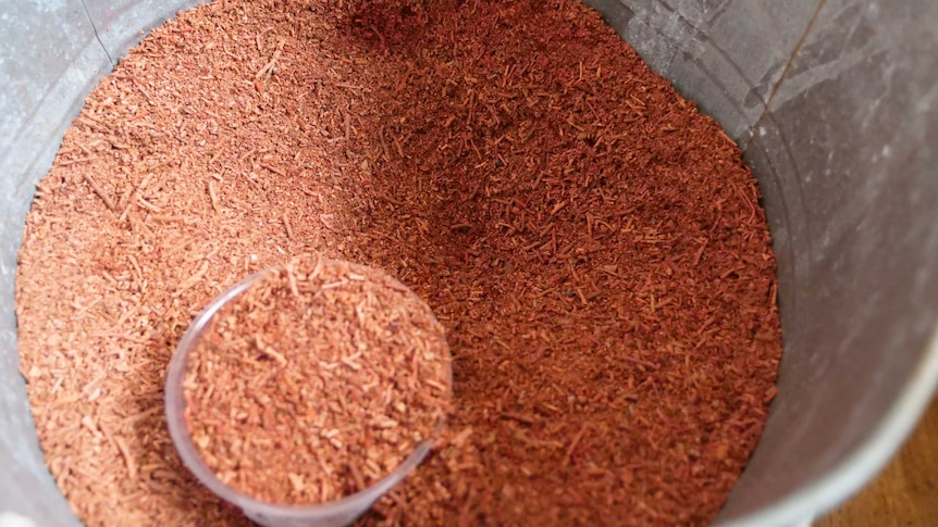 A close up of a bucket with saw dust