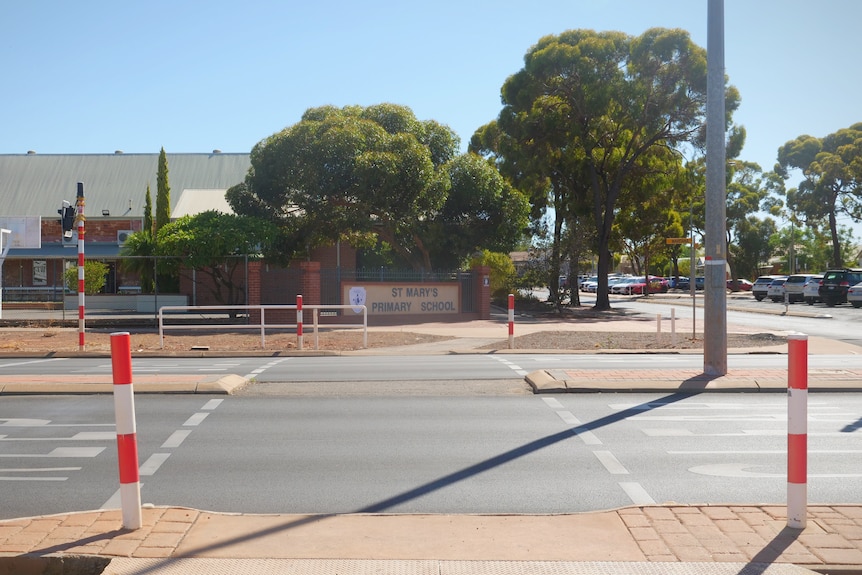 A crossing in front of a sign saying "St Mary's Primary School".
