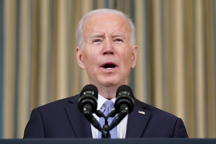 Head shot of Joe Biden speaking  from a lectern.