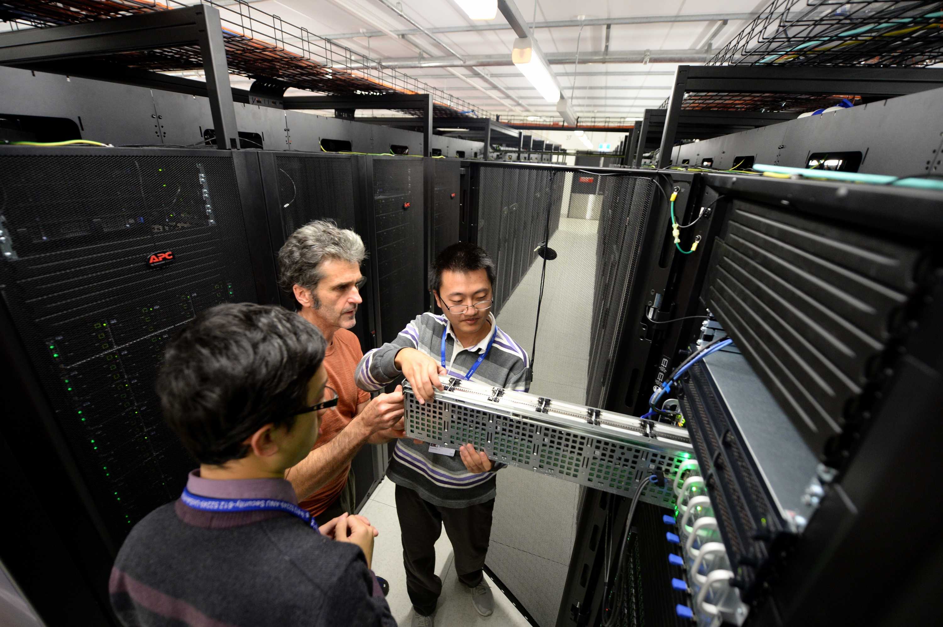 Staff check hard drives of the new super computer, named Raijin, at the Australian National University.