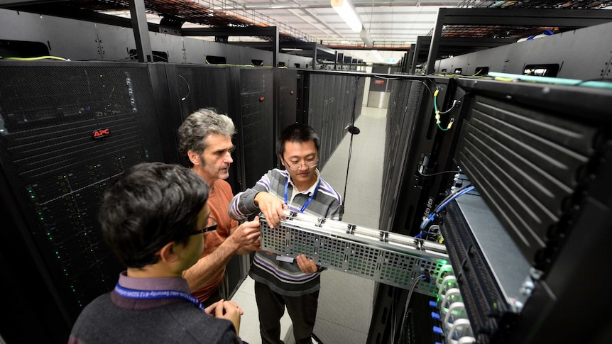 Staff check hard drives of the new super computer, named Raijin, at the Australian National University.
