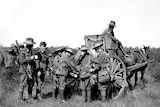 Soldiers milling around a Furphy water cart.