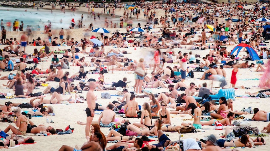People cover Bondi Beach in Sydney.