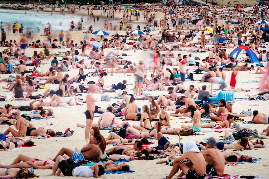 People cover Bondi Beach in Sydney.