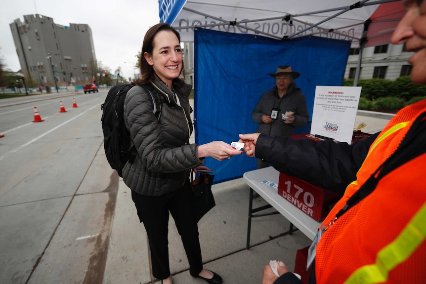 A woman casts her vote in Denver, Colorado which has approved magic mushroom use