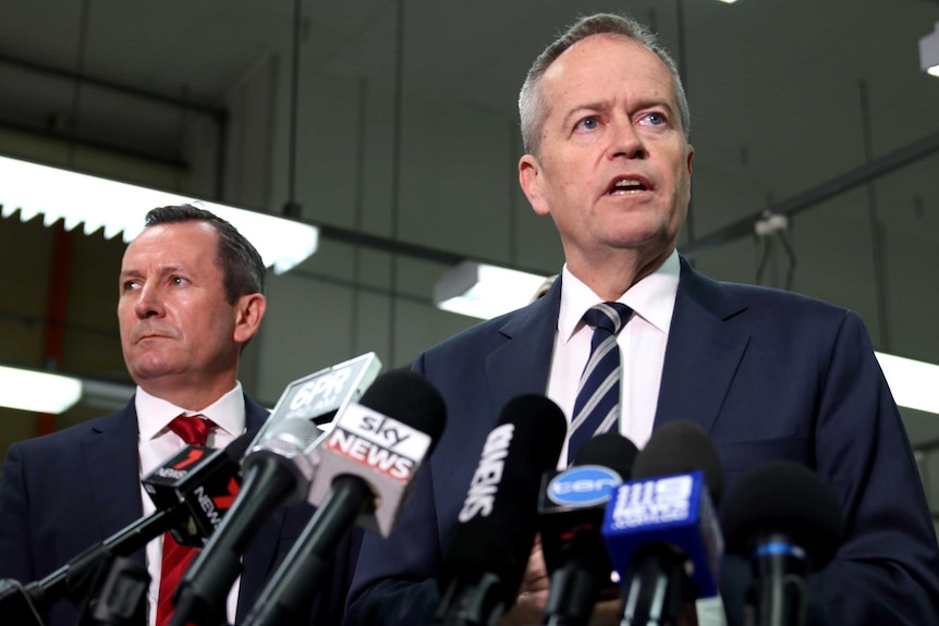 Mark McGowan and Bill Shorten in front of several media microphones.