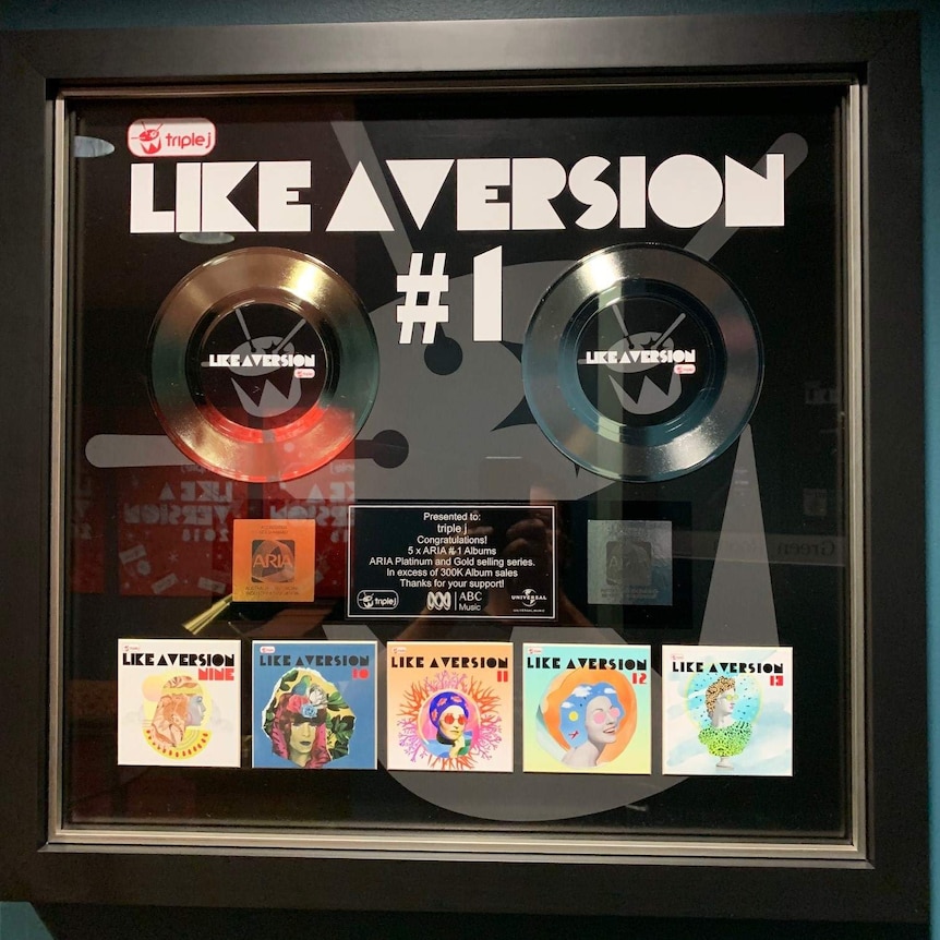 Records and Like A Version album covers in wall-mounted frame that has lettering saying #1.