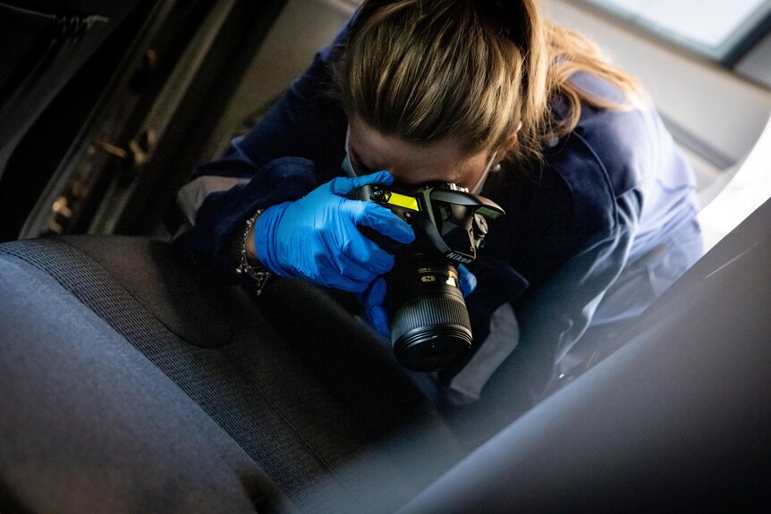 Forensic scientist Yolanda takes an image of a car seat. 