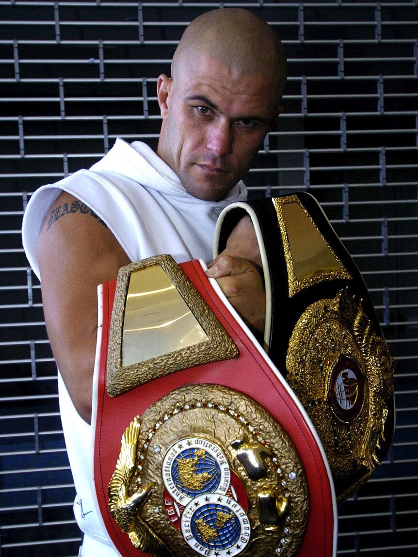 Shannan Taylor holds his IBF and WBF title belts in February 2005.