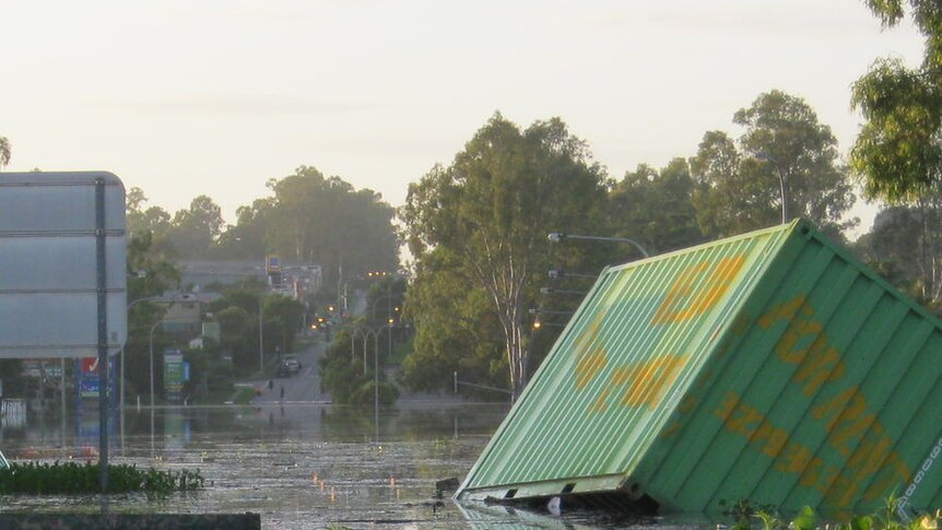 Debris: rubbish and cargo containers lie strewn across Blunder Road at Oxley