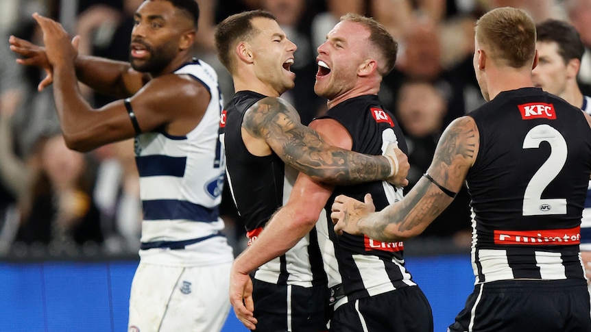 Tom Mitchell and Jamie Elliott hug and smile after a goal