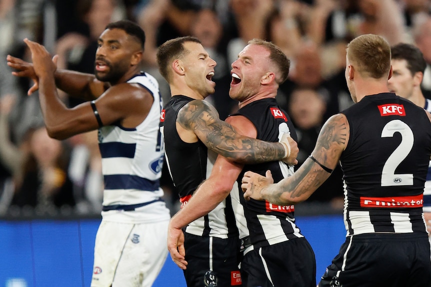 Tom Mitchell and Jamie Elliott hug and smile after a goal