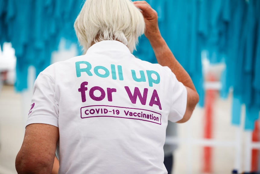 A woman wearing a tshirt with the words "Roll up for WA" printed on it.