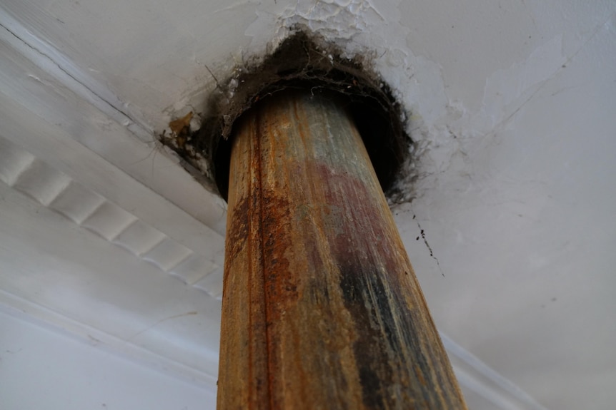 Where the fire flue enters the ceiling there's a two inch gap surrounded by black soot. 