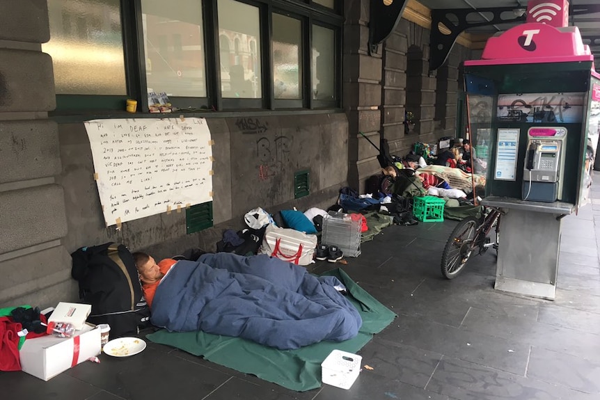 People sleeping outside Flinders Street station in Melbourne.