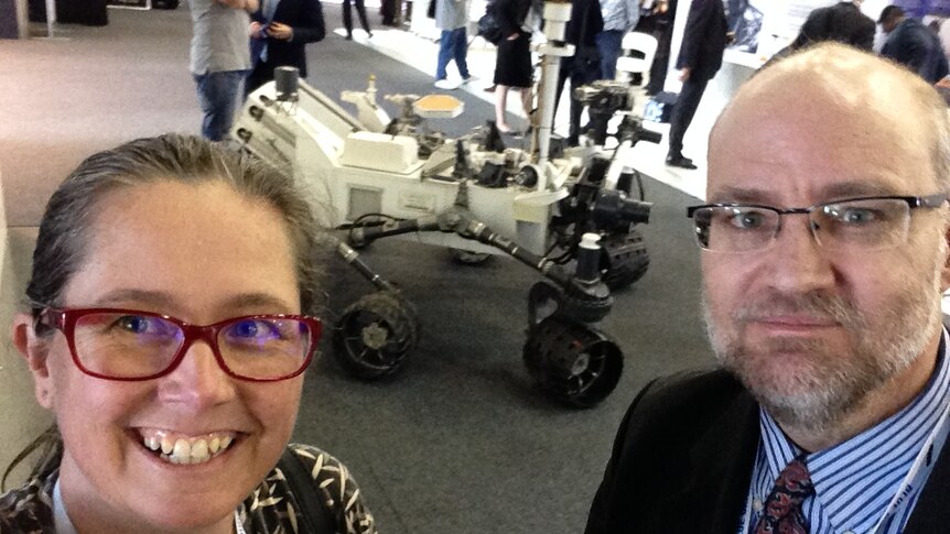 Nikki Coleman and Associate Professor Stephen Coleman stand in front of what appears to be a space rover.