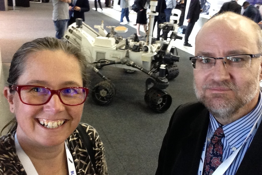Nikki Coleman and Associate Professor Stephen Coleman stand in front of what appears to be a space rover.