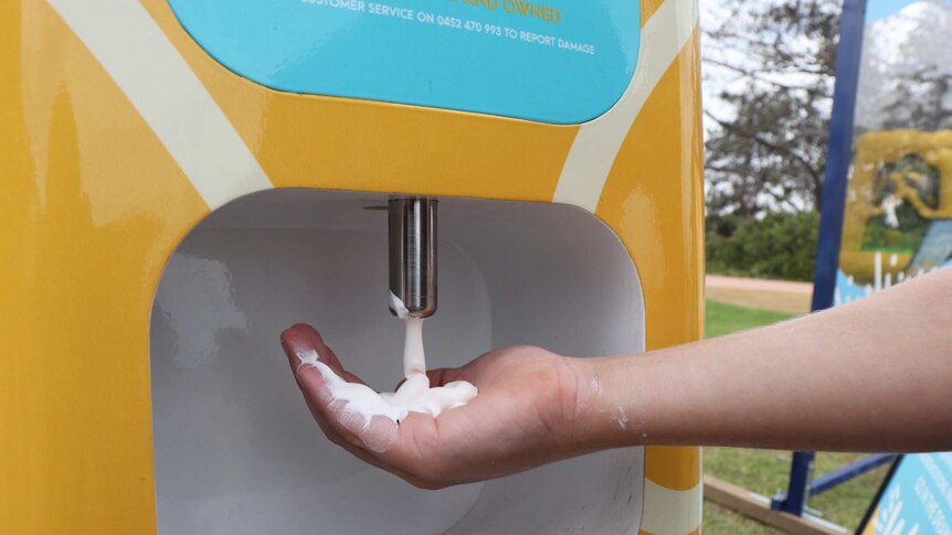 sunscreen being dispensed into a person's hand