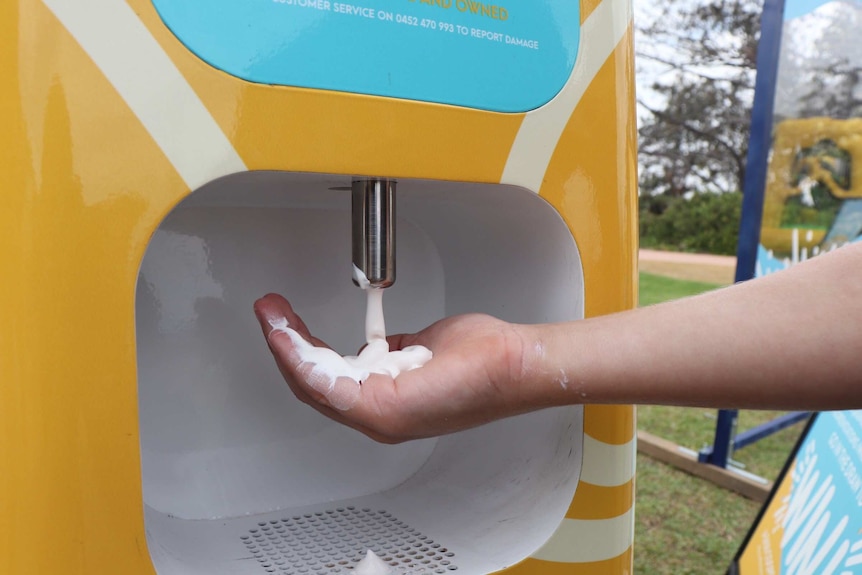 sunscreen being dispensed into a person's hand