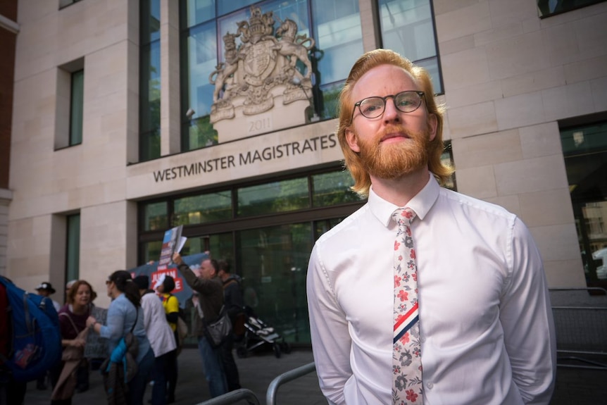 WikiLeaks ambassador Joseph A Farrell, has red hair, glasses, and wears a white shirt with floral tie outside court.