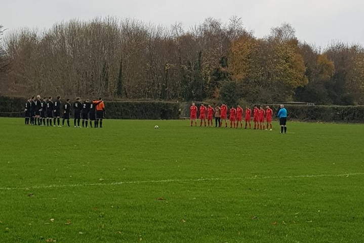 Liffey Wanderers players hold a minute's silence