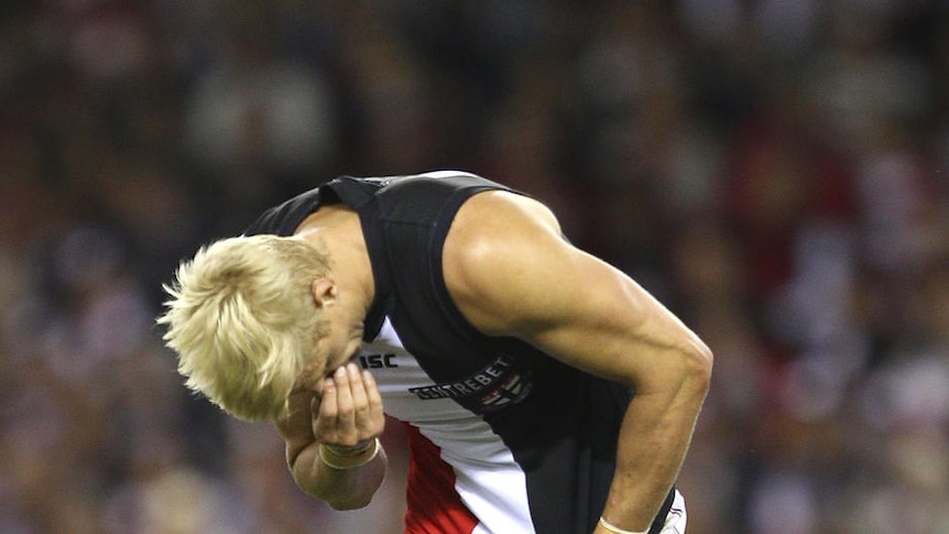 Down and out... Nick Riewoldt holds his nose during his team's 52-point defeat.