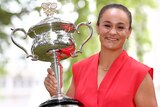 An Australian female tennis player poses for photographers with the Daphne Akhurst Memorial Cup.