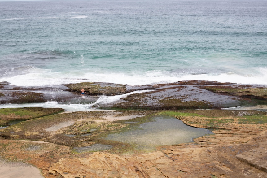 Waves crash onto rocks