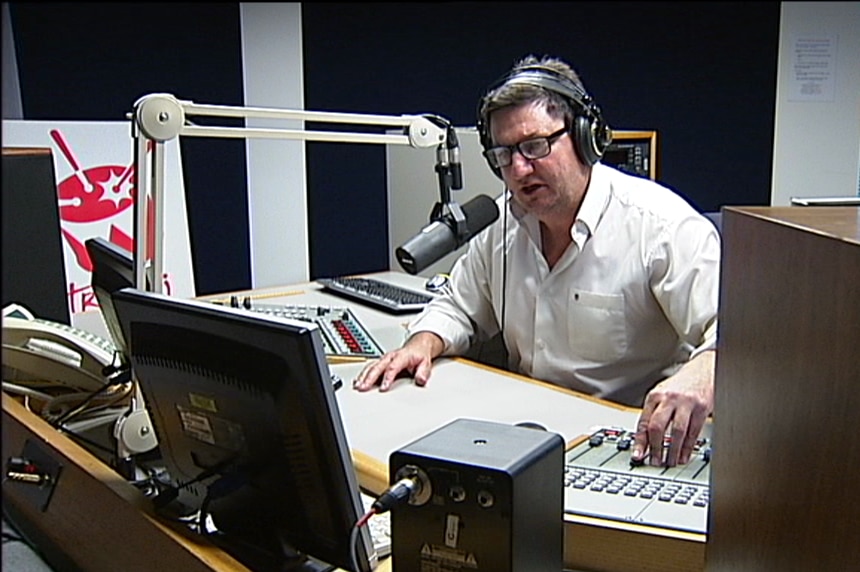 Gavel behind microphone in Canberra radio studio.