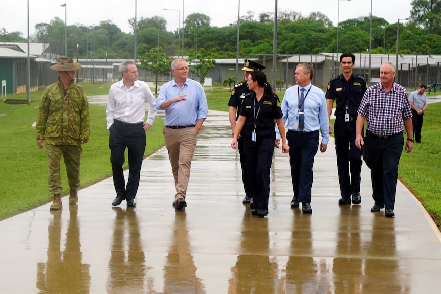 Scott Morrison walks in a line of people at the Christmas Island Detention Centre.