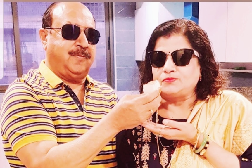 Kailash Tiwari and his wife wearing sunglasses pose feeding each other icde-cream. 