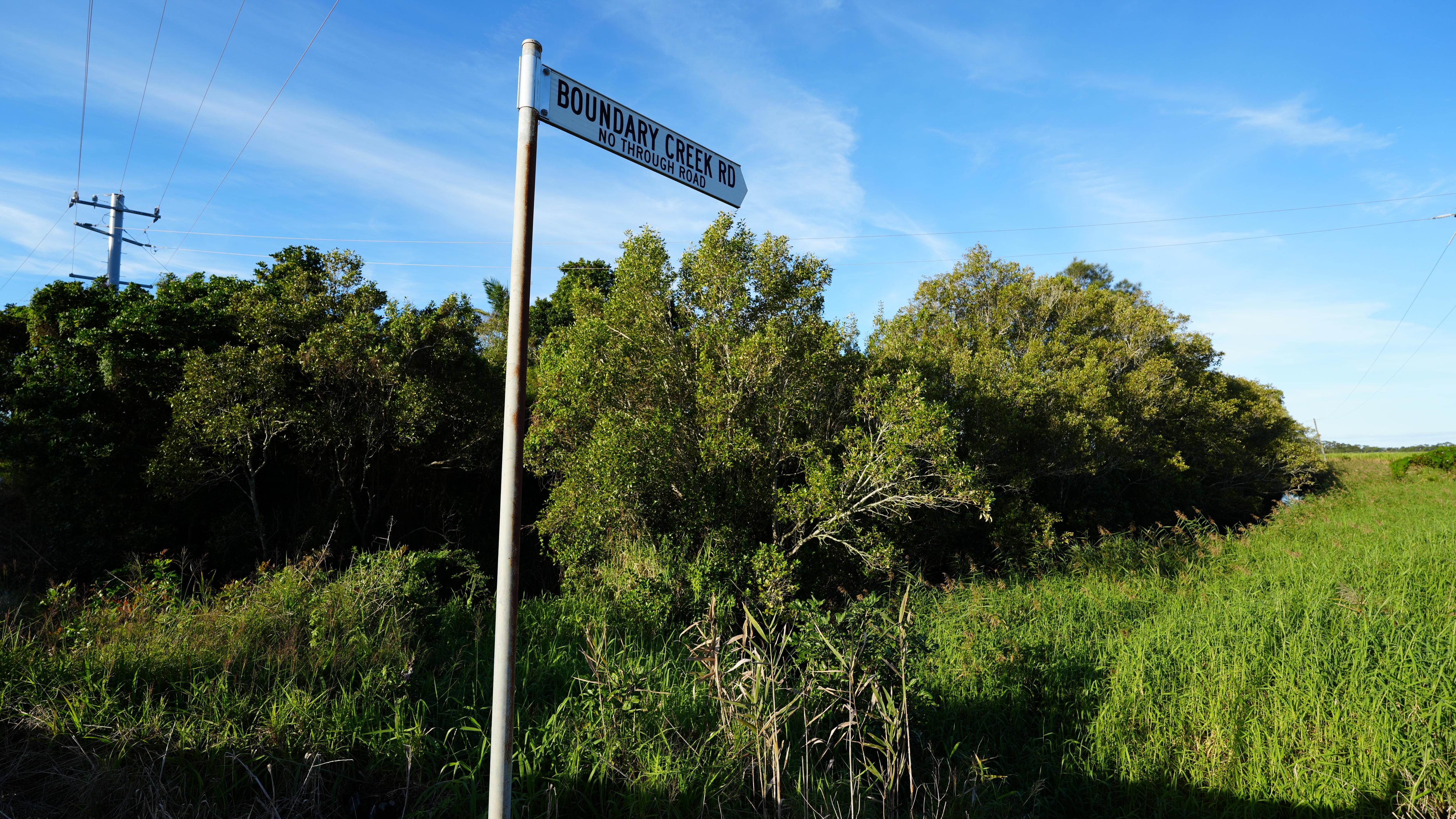 road sign with vegetation