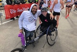 Two wheelchair athletes at the finish line of the race.