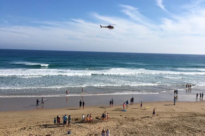 A helicopter flies over Fairhaven beach after a shark sighting