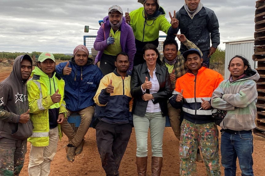 Image of International Mobility Services CEO Marcia Kelly with her staff.