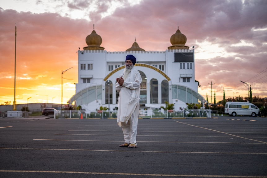 a man wearing a turban stands outside a sikh