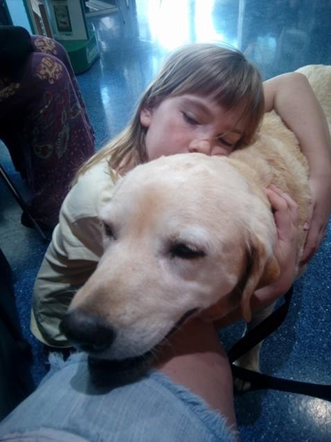 Aubrey Lee's daughter Jamie hugs family dog Sammy